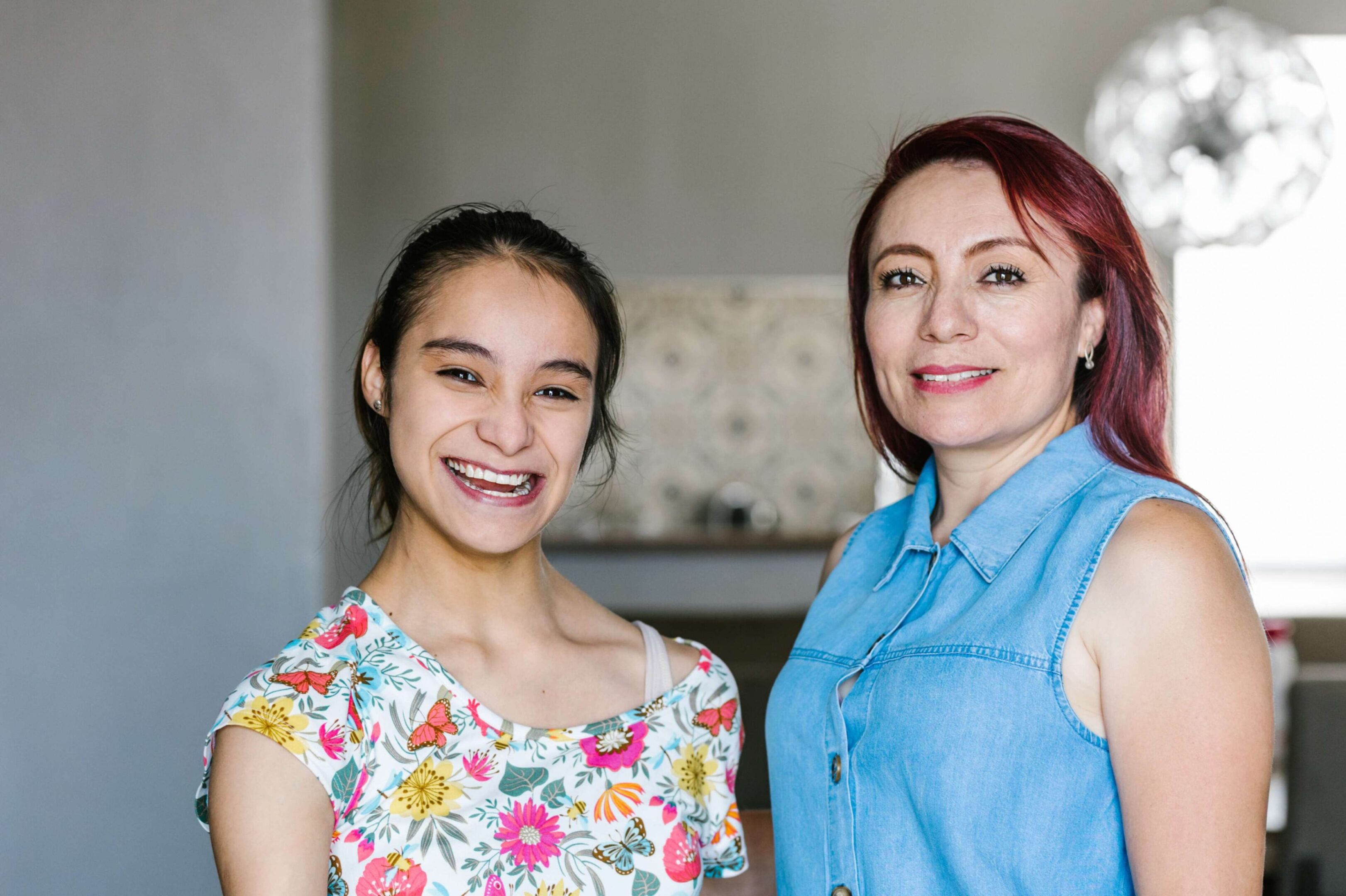 Two women smiling at the camera.